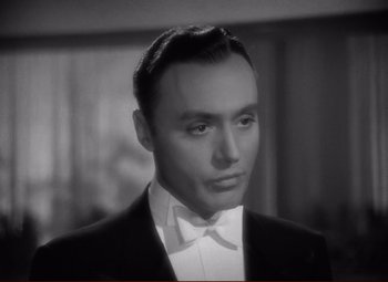 Movie still from “History Is Made at Night” (1937), directed by Frank Borzage – A man wearing a tuxedo and a bow tie; Close Up shot, High angle