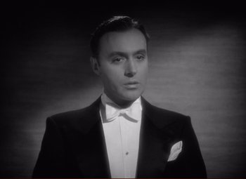 Movie still from “History Is Made at Night” (1937), directed by Frank Borzage – A man wearing a tuxedo and a white bow tie; Close Up shot, Low angle