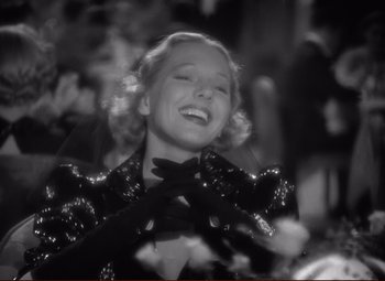Movie still from “History Is Made at Night” (1937), directed by Frank Borzage – A black - and - white photo of a woman smiling; Close Up shot, Low angle