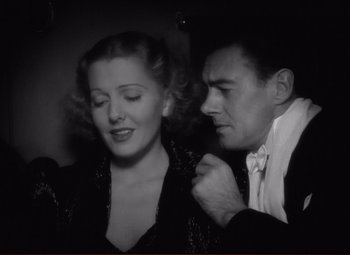 Movie still from “History Is Made at Night” (1937), directed by Frank Borzage – A man and a woman are posing for a picture; Close Up shot, Low angle