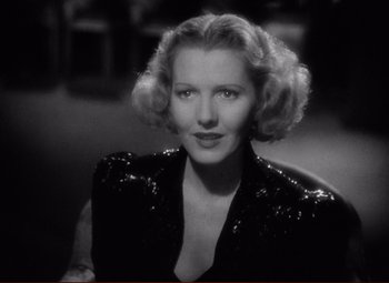 Movie still from “History Is Made at Night” (1937), directed by Frank Borzage – An old photo of a woman in a sequined jacket; Close Up shot, High angle