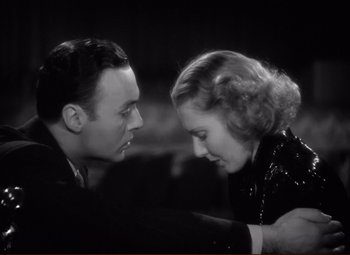 Movie still from “History Is Made at Night” (1937), directed by Frank Borzage – A man and a woman looking at one another; Close Up shot, High angle