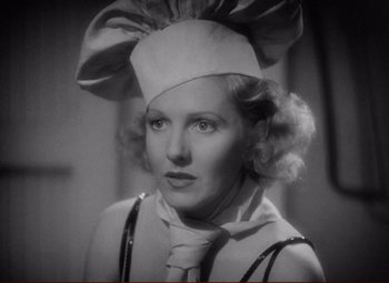 Movie still from “History Is Made at Night” (1937), directed by Frank Borzage – A woman wearing a white hat and a white dress; Close Up shot, Low angle