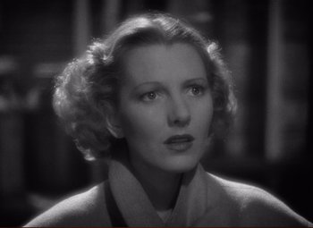 Movie still from “History Is Made at Night” (1937), directed by Frank Borzage – An old photo of an older woman in a sweater; Close Up shot, High angle