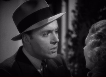 Movie still from “History Is Made at Night” (1937), directed by Frank Borzage – A man wearing a top hat and a suit; Close Up shot, Over the shoulder angle