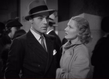 Movie still from “History Is Made at Night” (1937), directed by Frank Borzage – A man and a woman standing next to each other in front of a building; Close Up shot, Low angle