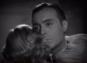 Movie still from “History Is Made at Night” (1937), directed by Frank Borzage – A black and white photo of a man kissing a woman; Close Up shot, High angle