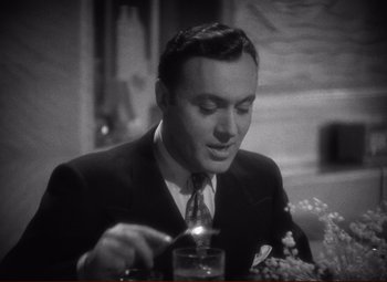 Movie still from “History Is Made at Night” (1937), directed by Frank Borzage – A black and white photo of a man in a suit and tie; Close Up shot, High angle