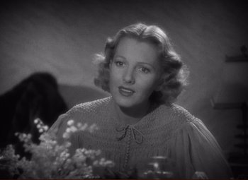 Movie still from “History Is Made at Night” (1937), directed by Frank Borzage – A black - and - white photo of a woman in a dress; Close Up shot, Over the shoulder angle