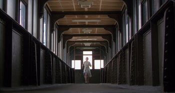 Movie still from “Unfaithful” (2002), directed by Adrian Lyne – A woman is walking down the stairs of a train; Wide shot, Low angle