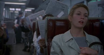 Movie still from “Unfaithful” (2002), directed by Adrian Lyne – A group of people sitting on a train holding newspapers; Close Up shot, Over the shoulder angle
