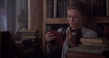 Movie still from “Unfaithful” (2002), directed by Adrian Lyne – A woman is reading a book in a library; Medium shot, Low angle