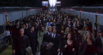 Movie still from “Unfaithful” (2002), directed by Adrian Lyne – A crowd of people walking down a train platform; Wide shot, High angle