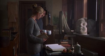 Movie still from “Unfaithful” (2002), directed by Adrian Lyne – Two women standing in front of an open book; Medium shot, Over the shoulder angle
