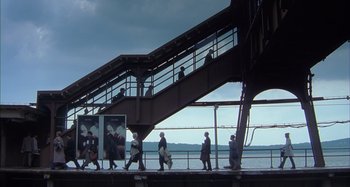 Movie still from “Unfaithful” (2002), directed by Adrian Lyne – A group of people walking up and down stairs; Extreme Wide shot, Low angle