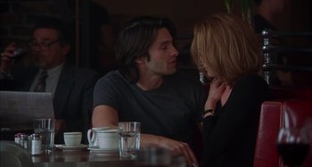 Movie still from “Unfaithful” (2002), directed by Adrian Lyne – A man and a woman sitting at a table; Medium shot, Over the shoulder angle