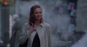 Movie still from “Unfaithful” (2002), directed by Adrian Lyne – A woman in a trench coat holding a purse; Medium shot, Low angle