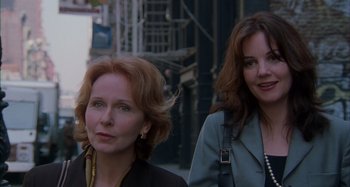 Movie still from “Unfaithful” (2002), directed by Adrian Lyne – Two women walking down a street in front of a building; Close Up shot, Low angle