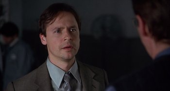 Movie still from “Unfaithful” (2002), directed by Adrian Lyne – A person wearing a suit and tie; Close Up shot, Over the shoulder angle