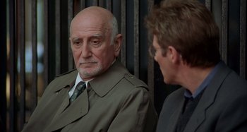 Movie still from “Unfaithful” (2002), directed by Adrian Lyne – An older man wearing a suit and tie talking to a younger man; Close Up shot, Over the shoulder angle