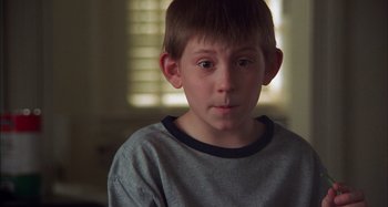 Movie still from “Unfaithful” (2002), directed by Adrian Lyne – A young boy is looking into the distance; Close Up shot, High angle