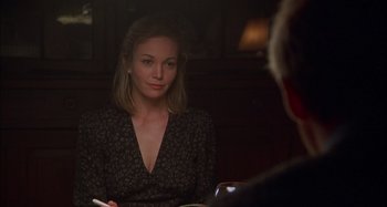 Movie still from “Unfaithful” (2002), directed by Adrian Lyne – A woman sitting in front of a man holding a cigarette; Medium shot, Over the shoulder angle
