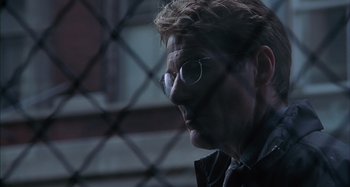 Movie still from “Unfaithful” (2002), directed by Adrian Lyne – A man wearing glasses looking out of a window; Close Up shot, Over the shoulder angle