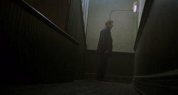Movie still from “Unfaithful” (2002), directed by Adrian Lyne – A man standing on the stairs of a building; Wide shot, Low angle