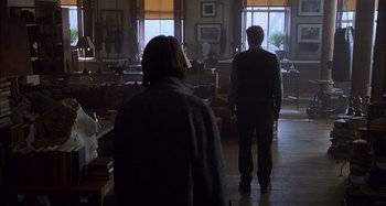 Movie still from “Unfaithful” (2002), directed by Adrian Lyne – A man and a woman standing in front of a window; Wide shot, Low angle