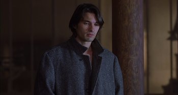 Movie still from “Unfaithful” (2002), directed by Adrian Lyne – A man with long black hair wearing a gray coat; Medium shot, Over the shoulder angle