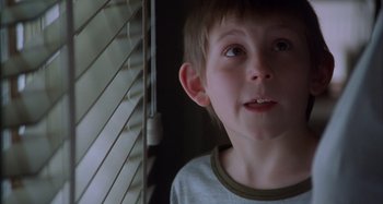Movie still from “Unfaithful” (2002), directed by Adrian Lyne – A young boy standing in front of a window; Close Up shot, Low angle