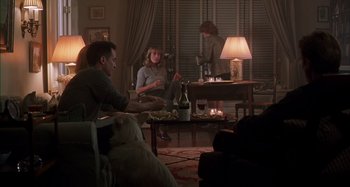 Movie still from “Unfaithful” (2002), directed by Adrian Lyne – A group of people sitting around a living room; Wide shot, Over the shoulder angle