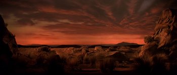 Movie still from “History of the World: Part I” (1981), directed by Mel Brooks – A red sky over a rocky area at sunset; Extreme Wide shot, Low angle
