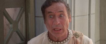 Movie still from “History of the World: Part I” (1981), directed by Mel Brooks – An old man wearing a roman outfit and looking surprised; Close Up shot, High angle
