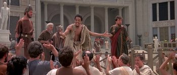 Movie still from “History of the World: Part I” (1981), directed by Mel Brooks – A group of men in ancient roman garb are clapping; Medium shot, High angle