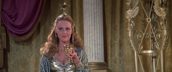 Movie still from “History of the World: Part I” (1981), directed by Mel Brooks – A woman in a silver dress holding a wine glass; Close Up shot, Low angle