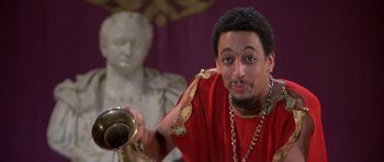 Movie still from “History of the World: Part I” (1981), directed by Mel Brooks – A man in a red and gold outfit holding a trumpet; Close Up shot, Low angle