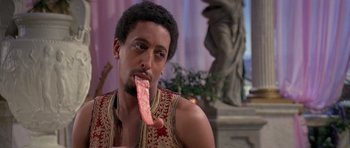 Movie still from “History of the World: Part I” (1981), directed by Mel Brooks – A man is eating a piece of meat; Close Up shot, Over the shoulder angle