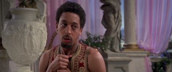 Movie still from “History of the World: Part I” (1981), directed by Mel Brooks – A person wearing a vest; Close Up shot, Over the shoulder angle