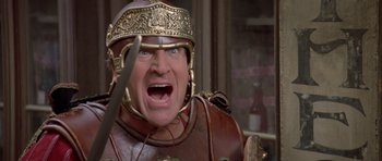 Movie still from “History of the World: Part I” (1981), directed by Mel Brooks – A person with a sword; Close Up shot, Low angle