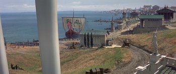 Movie still from “History of the World: Part I” (1981), directed by Mel Brooks – An image of a boat in the water near the shore; Extreme Wide shot, High angle