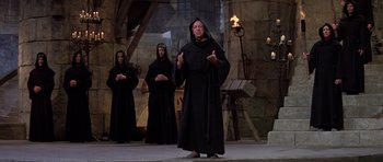 Movie still from “History of the World: Part I” (1981), directed by Mel Brooks – A group of people dressed up in black robes; Wide shot, High angle