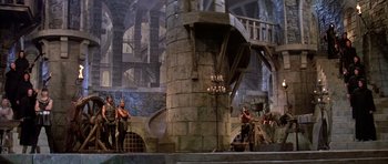 Movie still from “History of the World: Part I” (1981), directed by Mel Brooks – A group of men standing next to each other in front of a building; Extreme Wide shot, High angle