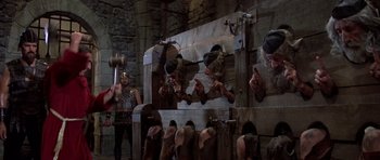 Movie still from “History of the World: Part I” (1981), directed by Mel Brooks – A group of men in medieval garb holding a hammer; Wide shot, High angle