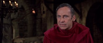 Movie still from “History of the World: Part I” (1981), directed by Mel Brooks – A man wearing a red robe and a red hood; Close Up shot, High angle
