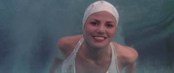 Movie still from “History of the World: Part I” (1981), directed by Mel Brooks – A woman in a white bathing suit and a white hat; Close Up shot, Low angle
