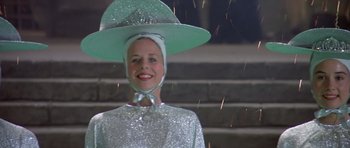 Movie still from “History of the World: Part I” (1981), directed by Mel Brooks – A woman wearing a hat and a silver dress; Medium shot, Low angle