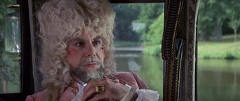 Movie still from “History of the World: Part I” (1981), directed by Mel Brooks – A man with a beard and a wig on; Close Up shot, Over the shoulder angle