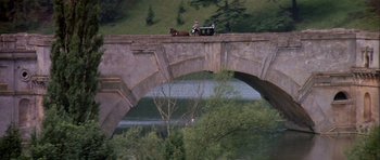 Movie still from “History of the World: Part I” (1981), directed by Mel Brooks – A horse drawn carriage crossing a bridge over a river; Extreme Wide shot, High angle