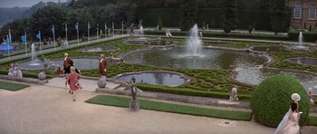 Movie still from “History of the World: Part I” (1981), directed by Mel Brooks – A fountain in the middle of a garden with statues; Extreme Wide shot, High angle